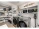 Efficient laundry room with modern appliances, organized shelving, and stylish décor for a functional space at 21271 E Smoky Hill Rd, Centennial, CO 80015
