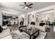 Spacious living room featuring an open floor plan, seamlessly connecting the kitchen, dining area, and staircase at 21271 E Smoky Hill Rd, Centennial, CO 80015