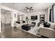 Bright and airy living room with fireplace, ceiling fan, comfortable seating, and seamless flow to the adjacent spaces at 21271 E Smoky Hill Rd, Centennial, CO 80015