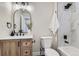 Bathroom with single vanity, tub, and marble tile shower at 6196 W 66Th Ave, Arvada, CO 80003