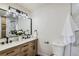 Double vanity bathroom with marble shower and modern lighting at 6196 W 66Th Ave, Arvada, CO 80003