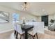 Modern dining area with a sleek table and chairs, and a view of the living room at 6196 W 66Th Ave, Arvada, CO 80003