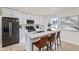 Modern kitchen with white cabinetry, quartz countertops, and stainless steel appliances at 6196 W 66Th Ave, Arvada, CO 80003