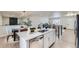 Modern kitchen island with white cabinets and stainless steel appliances at 6196 W 66Th Ave, Arvada, CO 80003