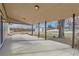 Covered patio with concrete flooring, providing shaded outdoor space at 6196 W 66Th Ave, Arvada, CO 80003