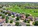 Aerial view showcasing golf course community surrounded by lush green spaces and well-maintained homes at 12000 Pine Top St, Parker, CO 80138