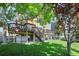 Home exterior with stairs leading to back decks overlooking spacious, well-maintained yard at 12000 Pine Top St, Parker, CO 80138