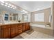 Main bathroom with dual vanity, soaking tub, and tile flooring at 12000 Pine Top St, Parker, CO 80138