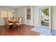 Elegant dining room with hardwood floors, chandelier, and sliding glass door to the backyard at 12000 Pine Top St, Parker, CO 80138