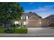 Charming two-story home features a well-manicured lawn, mature tree and a three car garage at 12000 Pine Top St, Parker, CO 80138