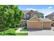Charming two-story home features a well-manicured lawn, mature tree and a three car garage at 12000 Pine Top St, Parker, CO 80138