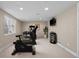 Bright home gym featuring modern fitness equipment and mounted television for entertainment at 12000 Pine Top St, Parker, CO 80138