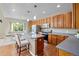 Kitchen with stainless steel appliances, wood cabinets, and a center island with seating at 12000 Pine Top St, Parker, CO 80138
