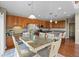 Kitchen with stainless steel appliances, a center island, wooden cabinets, and an adjacent dining area at 12000 Pine Top St, Parker, CO 80138