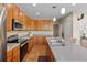 Kitchen featuring stainless steel appliances, wood cabinets, and a center island at 12000 Pine Top St, Parker, CO 80138
