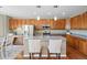 A kitchen showcases wood cabinets, a center island with seating and hardwood floors at 12000 Pine Top St, Parker, CO 80138