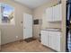 Practical laundry room features sink, ample cabinet storage, and a large window at 12000 Pine Top St, Parker, CO 80138