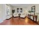 Cozy living room featuring hardwood floors, large windows, and neutral-toned decor at 12000 Pine Top St, Parker, CO 80138