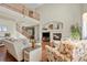 Spacious living room with a fireplace, wood floors, and a view of the second-floor landing at 12000 Pine Top St, Parker, CO 80138