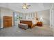 Spacious main bedroom with tray ceiling, plush carpet, and natural light at 12000 Pine Top St, Parker, CO 80138
