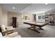 Spacious recreation room with a pool table, seating, and built in shelving with games at 12000 Pine Top St, Parker, CO 80138