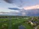 Panoramic aerial view of sports fields, lake, and residential area beneath a dramatic sky at 10723 W 54Th Pl, Arvada, CO 80002
