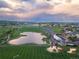Breathtaking aerial view showcasing a serene lake, lush green sports fields, and the cityscape at 10723 W 54Th Pl, Arvada, CO 80002
