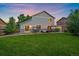 Backyard with a patio with a swing, outdoor dining, and lush grass, ideal for relaxation and entertainment at 10723 W 54Th Pl, Arvada, CO 80002