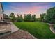 Landscaped backyard featuring a lush lawn and a stone-lined edge, creating a serene outdoor retreat at 10723 W 54Th Pl, Arvada, CO 80002