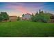 The sprawling backyard features lush greenery, mature trees, and an inviting patio, perfect for outdoor enjoyment at 10723 W 54Th Pl, Arvada, CO 80002