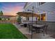 Outdoor patio area with dining set, and swing providing an inviting space for gatherings and relaxation at 10723 W 54Th Pl, Arvada, CO 80002