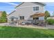 An inviting backyard patio with a swing, seating area, and dining set, perfect for outdoor entertaining at 10723 W 54Th Pl, Arvada, CO 80002