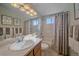 Bright bathroom featuring a clean vanity, decorative mirror, and a shower-tub combo, creating a refreshing and stylish space at 10723 W 54Th Pl, Arvada, CO 80002