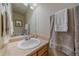 Cozy bathroom with a clean single sink vanity, framed mirror, and decorative towels for a comfortable, stylish space at 10723 W 54Th Pl, Arvada, CO 80002