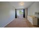 Spacious bedroom with plush carpet and a dresser providing ample storage, creating a comfortable and inviting atmosphere at 10723 W 54Th Pl, Arvada, CO 80002
