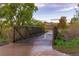 A concrete bridge surrounded by trees and greenery providing a tranquil pathway at 10723 W 54Th Pl, Arvada, CO 80002