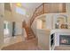 Inviting entryway featuring a staircase, fireplace, and abundant natural light, creating a warm and welcoming ambiance at 10723 W 54Th Pl, Arvada, CO 80002
