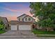 Charming two-story home with a three-car garage and well-manicured lawn at 10723 W 54Th Pl, Arvada, CO 80002