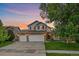 Charming two-story home with a three-car garage and well-manicured lawn at 10723 W 54Th Pl, Arvada, CO 80002