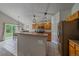 Bright kitchen with stainless steel appliances, tile floors, pendant lighting, and access to backyard at 10723 W 54Th Pl, Arvada, CO 80002