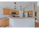 Kitchen features stainless steel appliances, tile floors, pendant lights, and peninsula seating at 10723 W 54Th Pl, Arvada, CO 80002