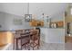 Open concept eat-in kitchen features stainless appliances, pendant lighting, and adjacent dining area at 10723 W 54Th Pl, Arvada, CO 80002