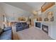 Spacious living room features an open layout, fireplace, and modern lighting at 10723 W 54Th Pl, Arvada, CO 80002