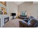 Cozy living room with a fireplace, a large window, and plush seating at 10723 W 54Th Pl, Arvada, CO 80002
