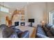 Bright living room with a fireplace, comfortable seating, and staircase at 10723 W 54Th Pl, Arvada, CO 80002