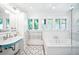 Stylish bathroom with a unique blue sink, vintage faucets, and a soaking tub at 677 N Gilpin St, Denver, CO 80218