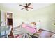 This bedroom features a pull-out daybed, ceiling fan, hardwood floors, and lots of natural light at 677 N Gilpin St, Denver, CO 80218