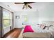 Bright bedroom featuring hardwood floors, natural light, and colorful décor at 677 N Gilpin St, Denver, CO 80218