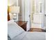 Comfortable bedroom featuring a nightstand, a lamp, and a bathroom visible through an open doorway at 677 N Gilpin St, Denver, CO 80218