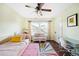 Charming bedroom with a daybed, ceiling fan, and large window, creating a warm and inviting space at 677 N Gilpin St, Denver, CO 80218